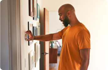 Man adjusting thermostat