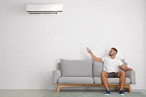 Man%20sitting%20next%20to%20AC%20unit