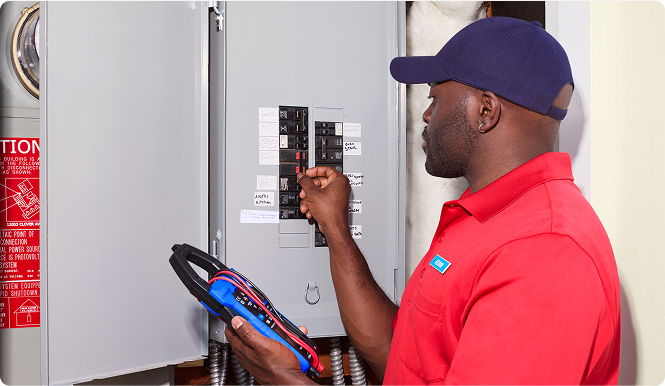 technician inspecting breaker box