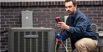 Pro inspecting outdoor appliance